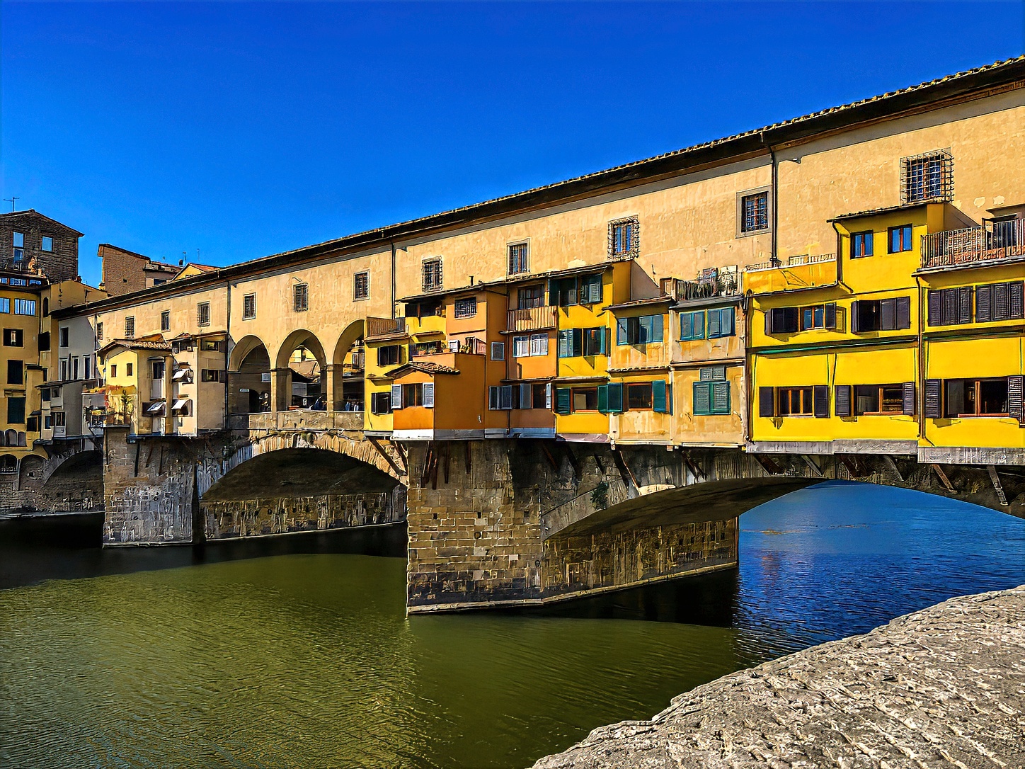 The Ponte Vecchio across the Arno, its shops overhanging the water.