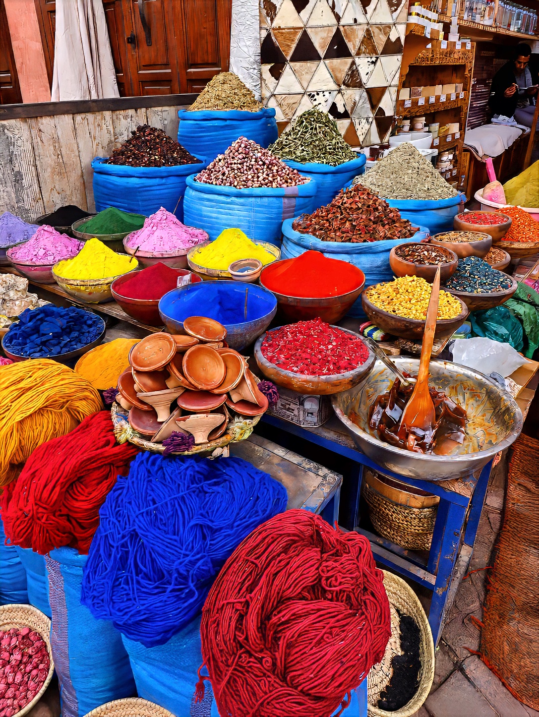Cones of coloured pigment and spice powders displayed in rows.