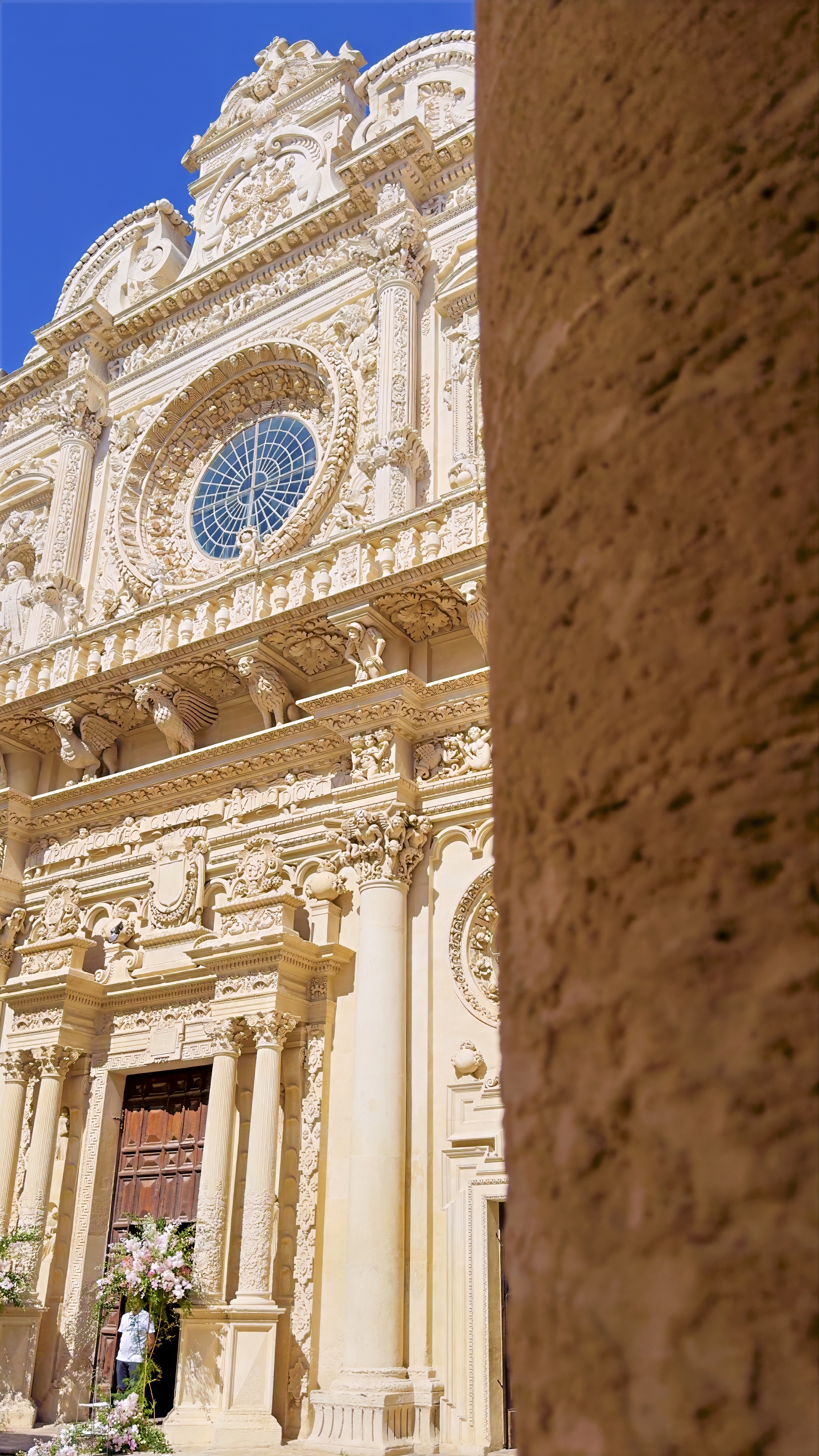 The carved baroque façade and rose window of the Basilica di Santa Croce in Lecce.