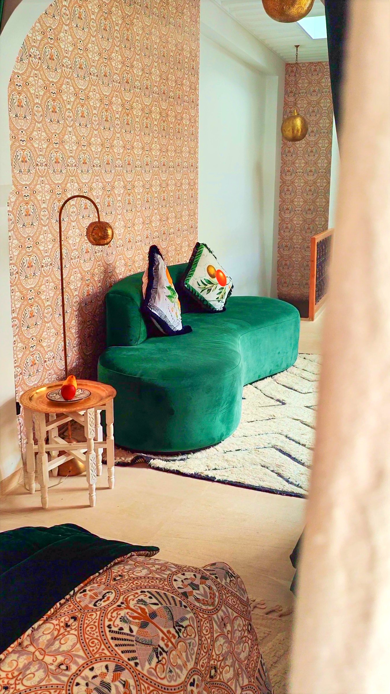The salon, with a long green sofa and cushions