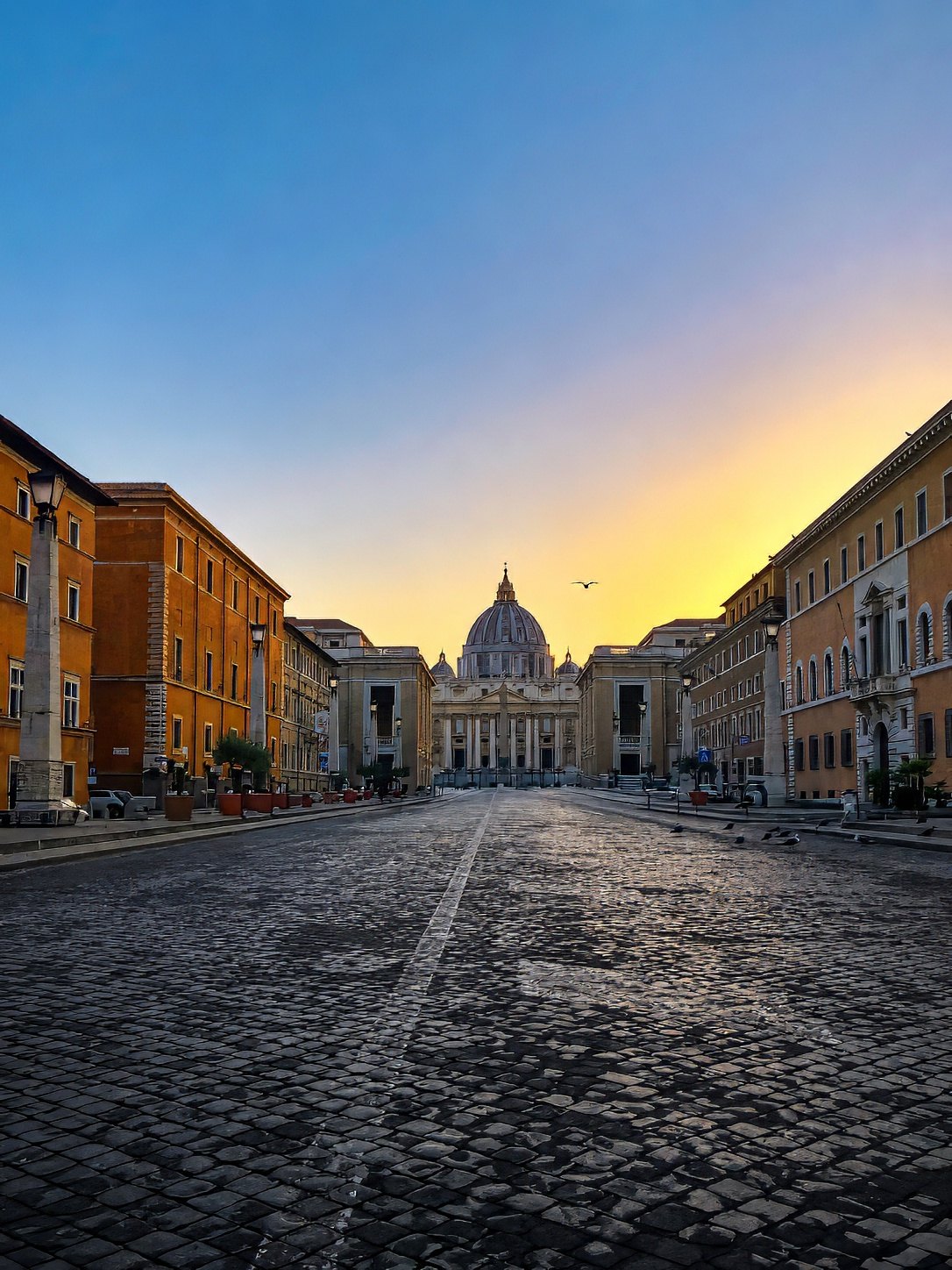 Via della Conciliazione leading to the dome of St Peter's Basilica at dusk