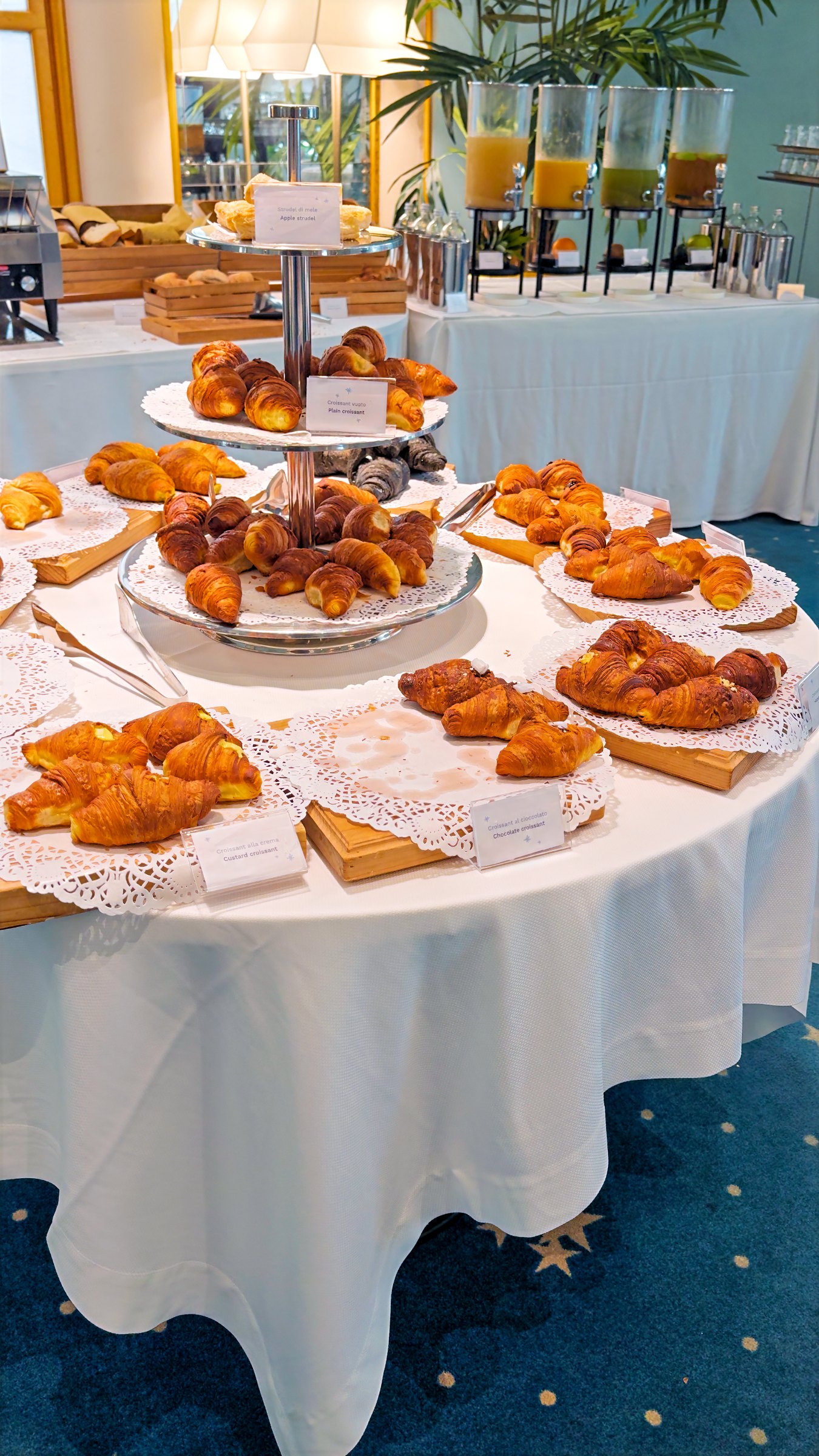 Croissants and pastries on tiered stands at the breakfast buffet